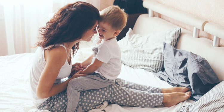 Mother and her child relaxing in the morning with pyjamas on